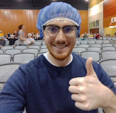 A volunteer giving a thumbs up