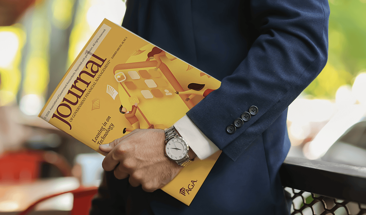 A man in a suit holding a financial journal.