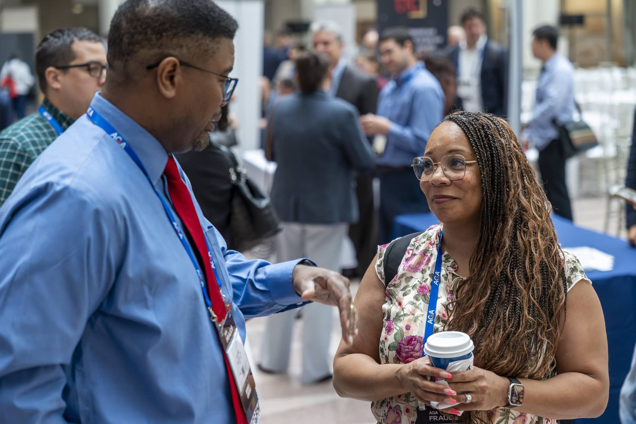 A man and woman talking at an AGA Event.